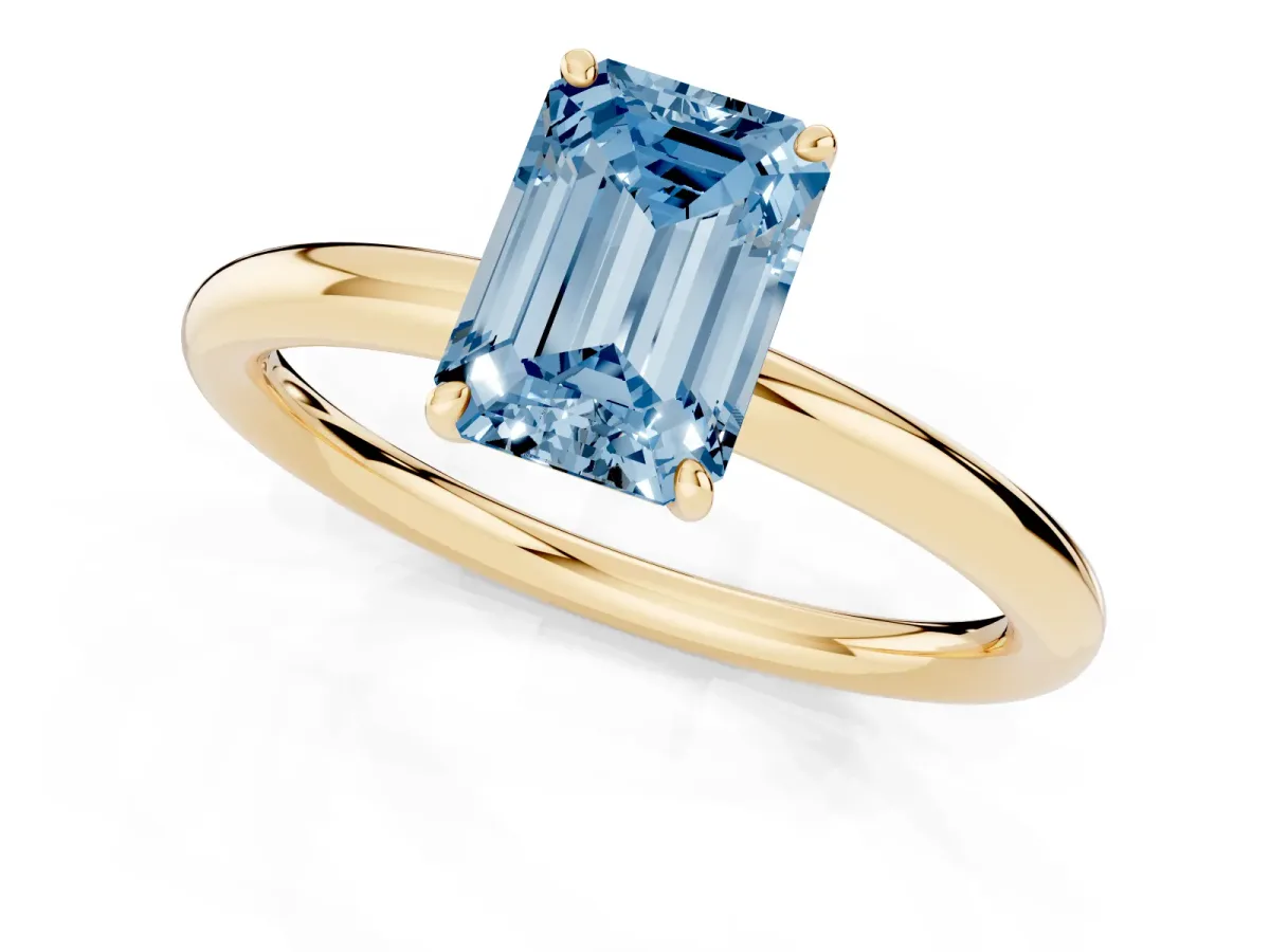 Fancy Blue Emerald Cut Solitaire Diamond Ring with Four-Prong Setting on a Plain Band Yellow gold