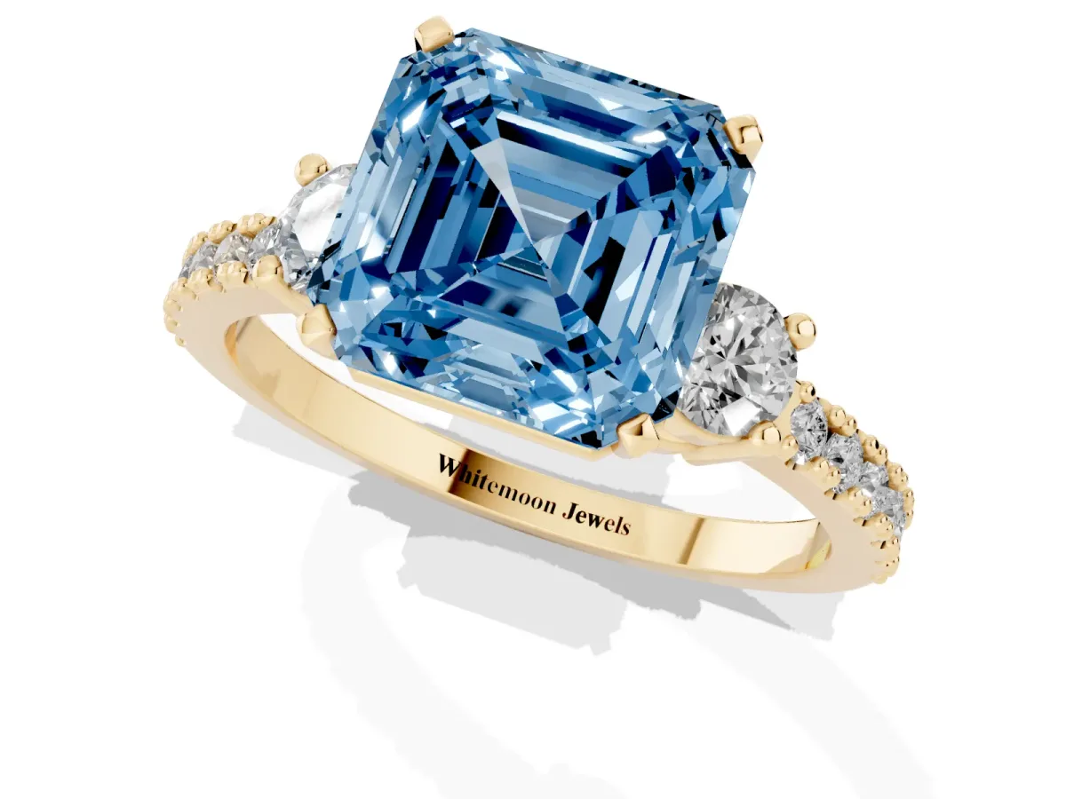 Fancy Blue Asscher Cut Three-Stone Diamond Pavé Band with Prong Setting Yellow gold
