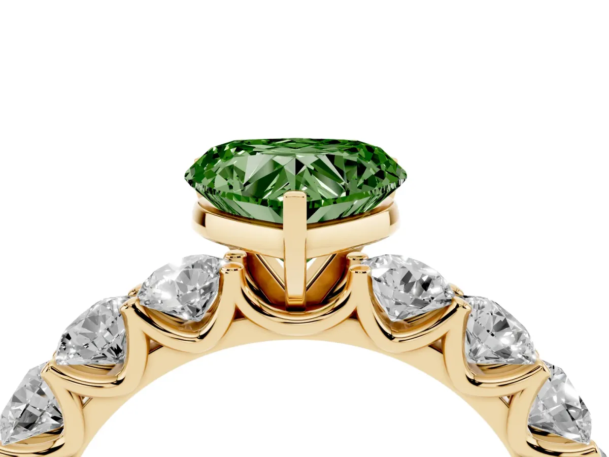 Fancy Green Heart Cut Diamond Prong Setting with Side Stones on a Pave Band Yellow gold