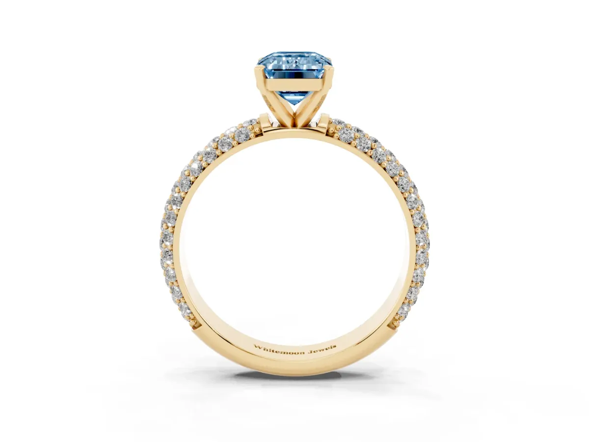 Fancy Blue Emerald Cut Diamond Solitaire Ring with Prong Setting and Pavé Band Yellow gold