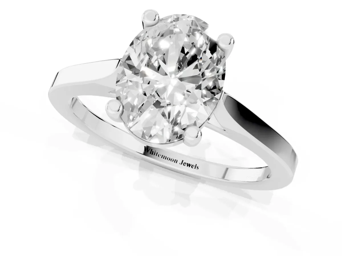 Oval Cut Solitaire Diamond Ring with Four-Prong Setting and Tapered Band Silver