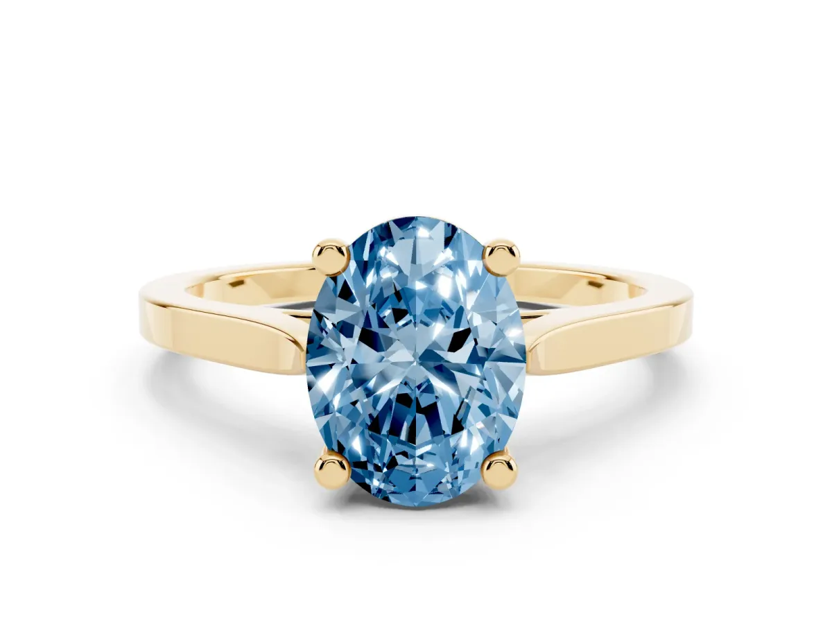 Fancy Blue Oval Cut Solitaire Diamond Ring with Four-Prong Setting and Tapered Band Yellow gold
