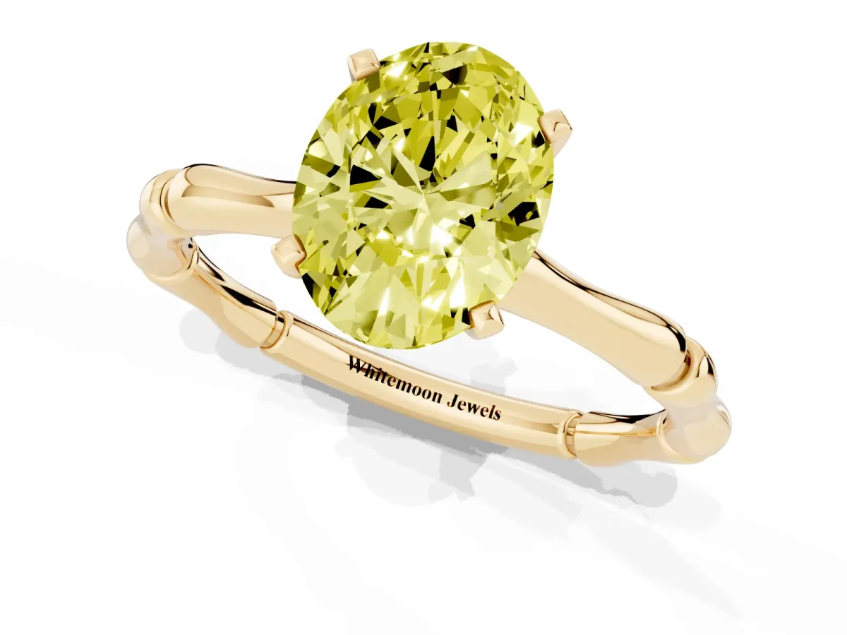 Fancy Yellow Oval Cut Solitaire Diamond Ring with Bamboo Band and Four-Prong Setting Yellow gold