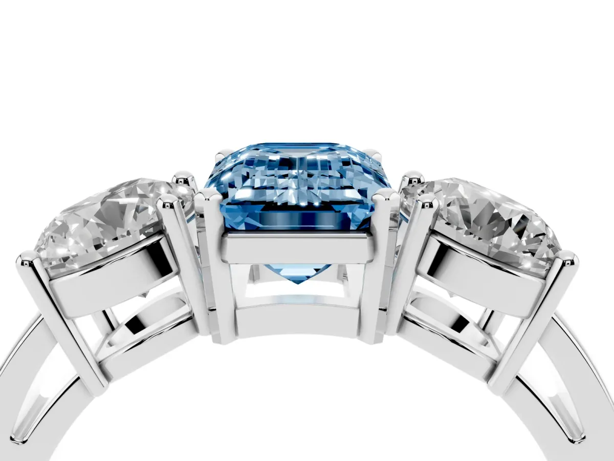 Fancy Blue Three-Stone Emerald Cut Diamond Ring with Round Side Stones, Classic Band, and Four-Prong Setting Silver
