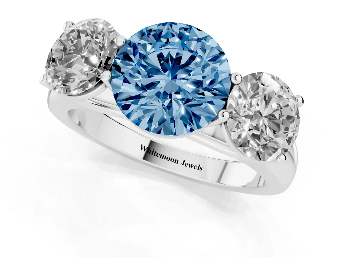 Fancy Blue Round Cut Three-Stone Diamond Ring with Prong Setting on a Classic Band Silver