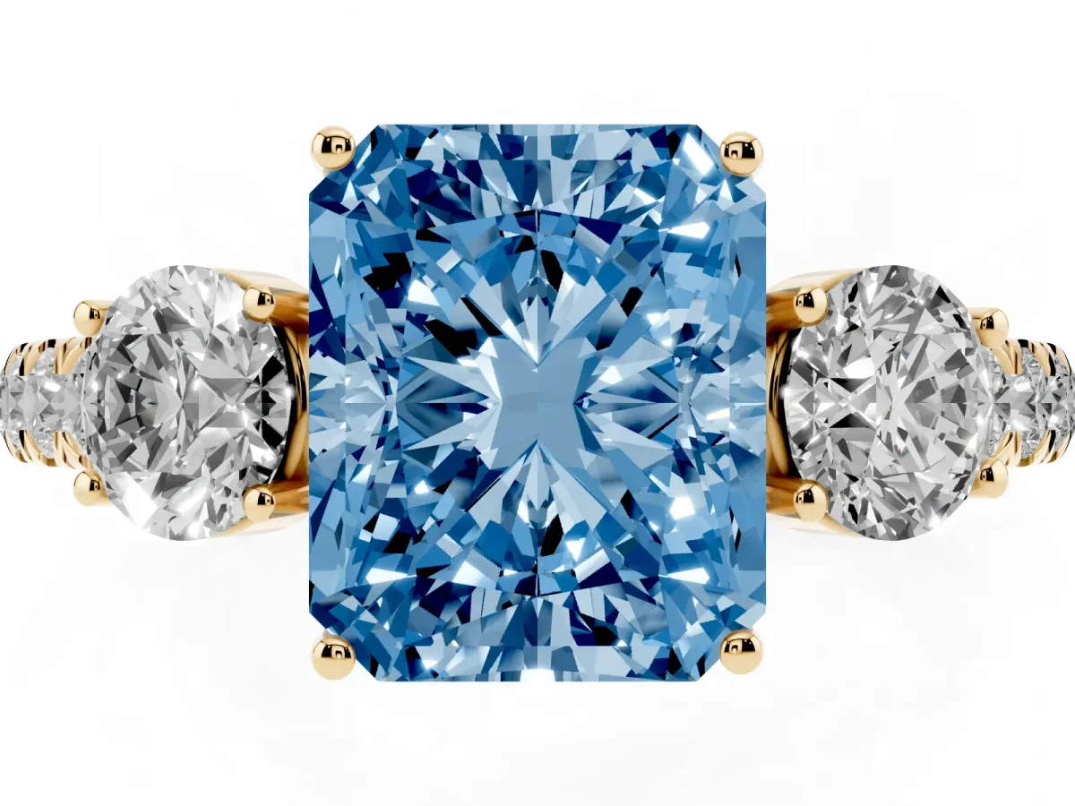 Fancy Blue Radiant Cut Cut Diamond Three-Stone Ring with Round Side Stones and Pavé Band Yellow gold