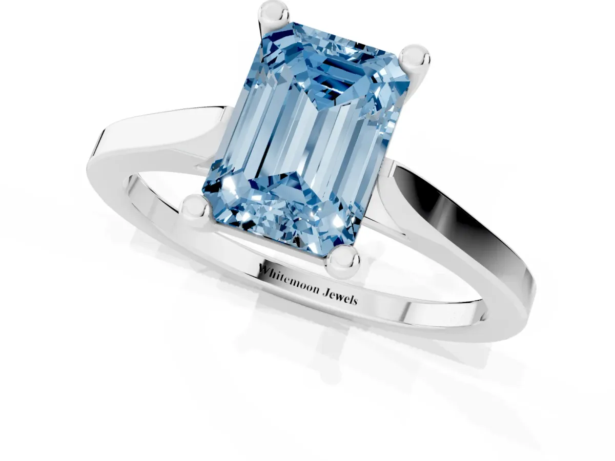 Fancy Blue Emerald Cut Solitaire Diamond Ring with Four-Prong Setting and Tapered Band Silver
