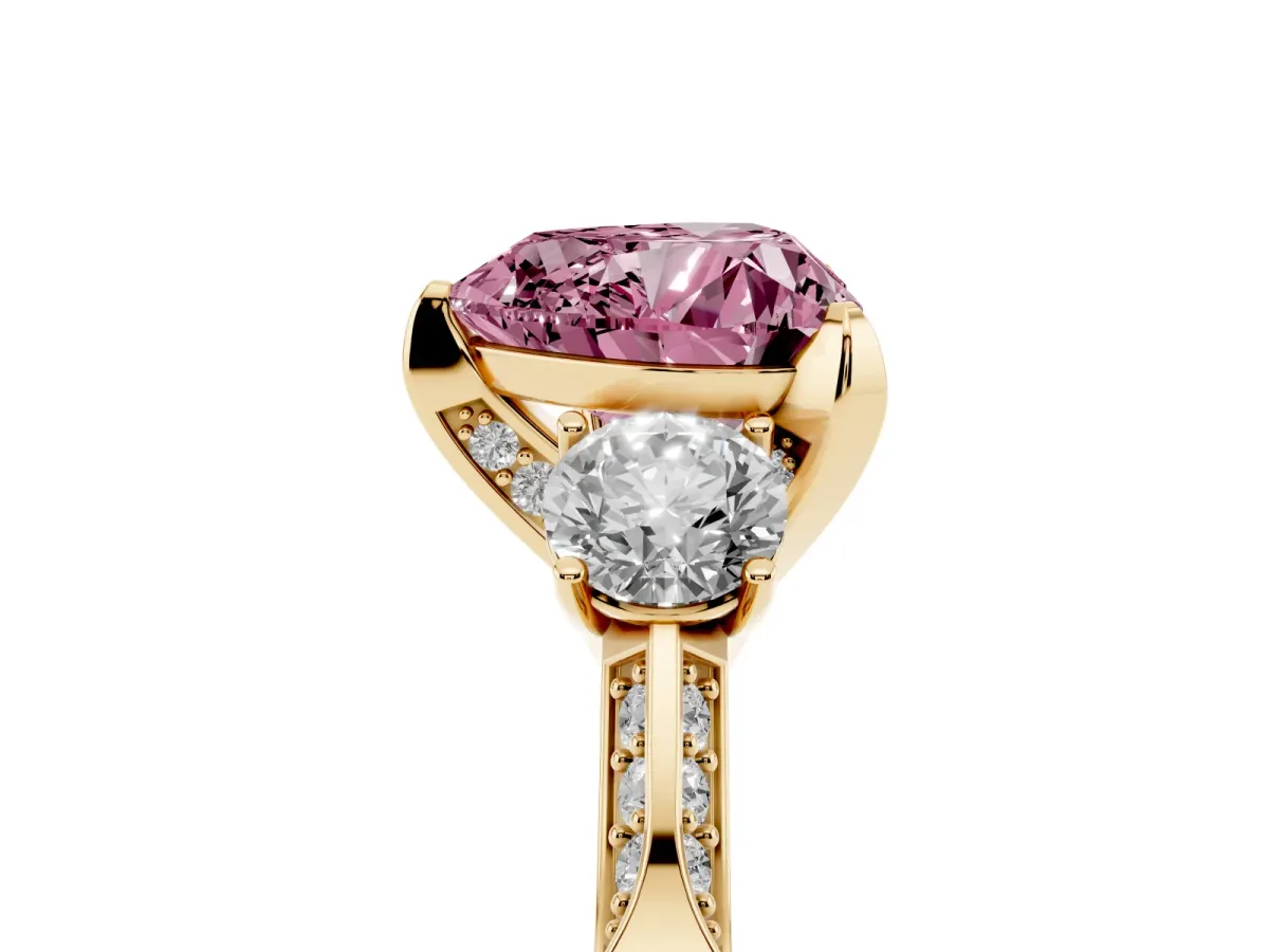Fancy Pink Heart Cut Brilliant Three-Stone Diamond Ring with Pavé Band and Four-Prong Setting Yellow gold
