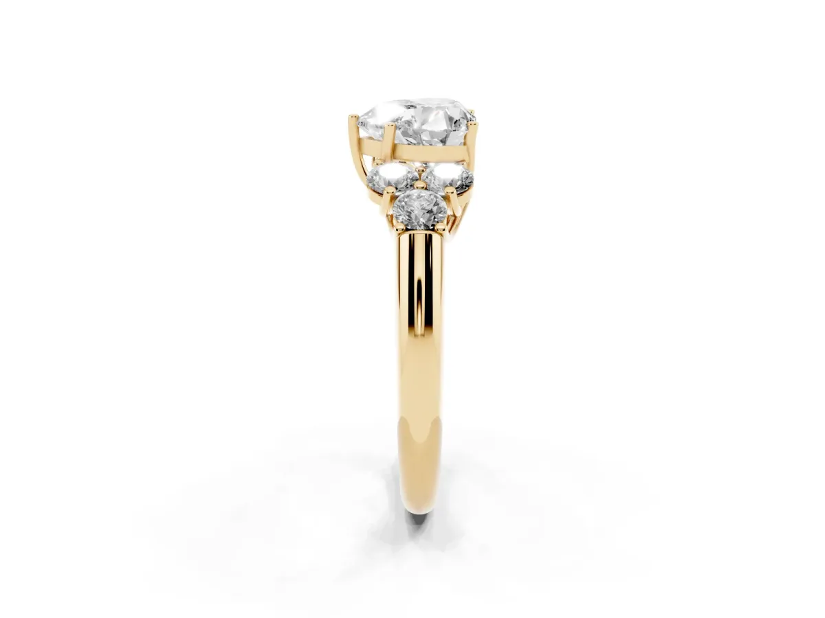 Heart Cut Cut Diamond Cluster Ring with Round Accent Stones and Prong Setting on a Classic Band Yellow gold