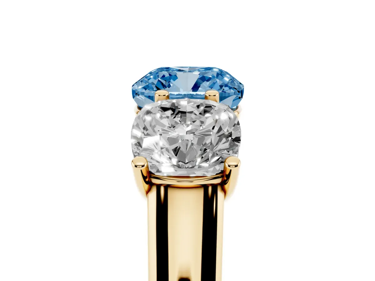 Fancy Blue Cushion Cut Three-Stone Diamond Ring with Prong Setting on a Classic Band Yellow gold