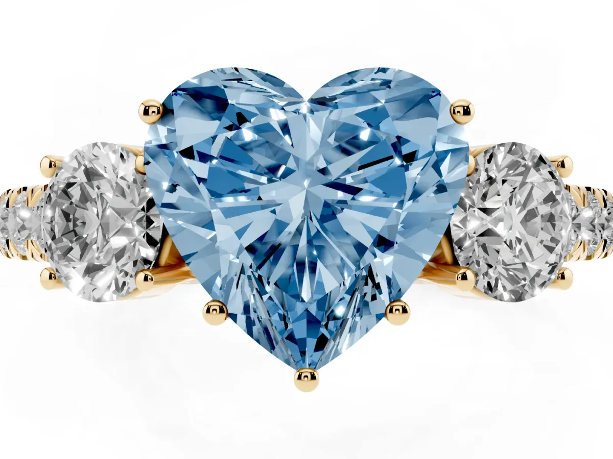 Fancy Blue Heart Cut Cut Diamond Three-Stone Ring with Round Side Stones and Pavé Band Yellow gold