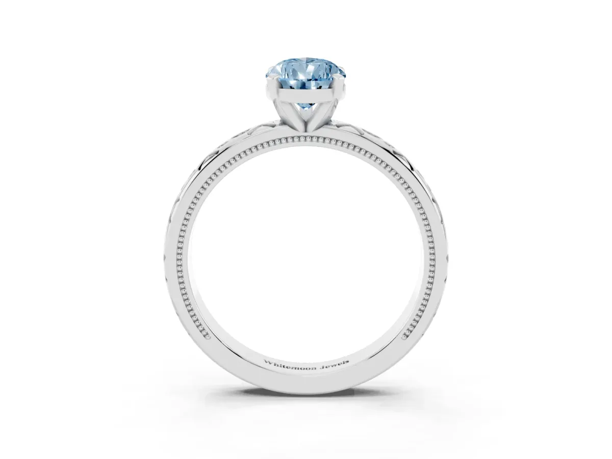Fancy Blue Pear Cut Solitaire Engagement Ring with Scrollwork Band and Four-Prong Setting Silver