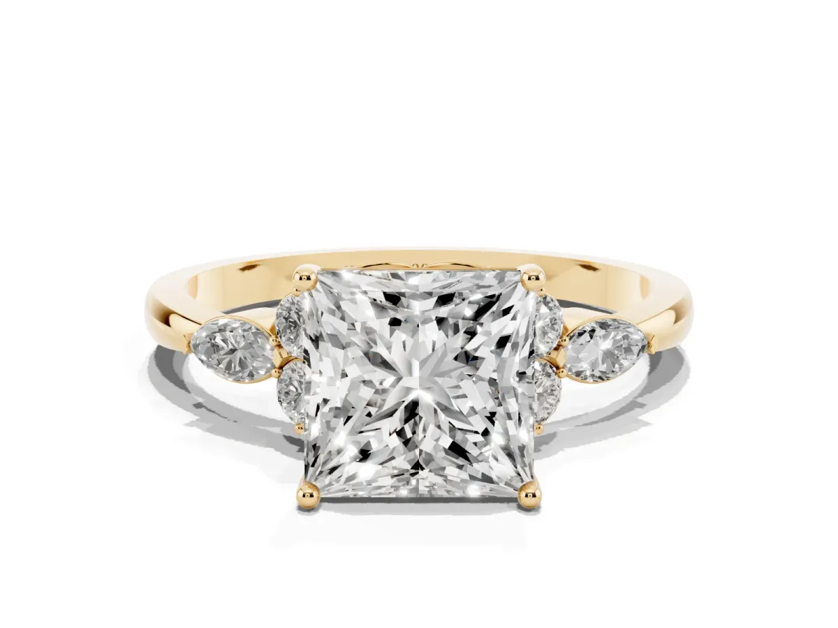 Princess Cut Brilliant Diamond Solitaire Ring with Pear Side Stones and Four-Prong Setting Yellow gold