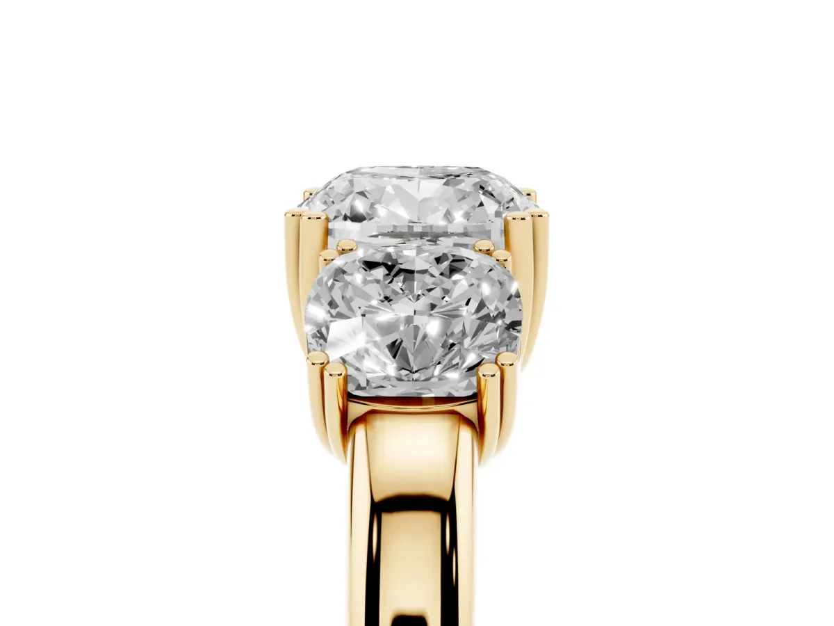 Three-Stone Cushion Cut Cut Diamond Ring with Channel Set Band and Four-Prong Setting Yellow gold