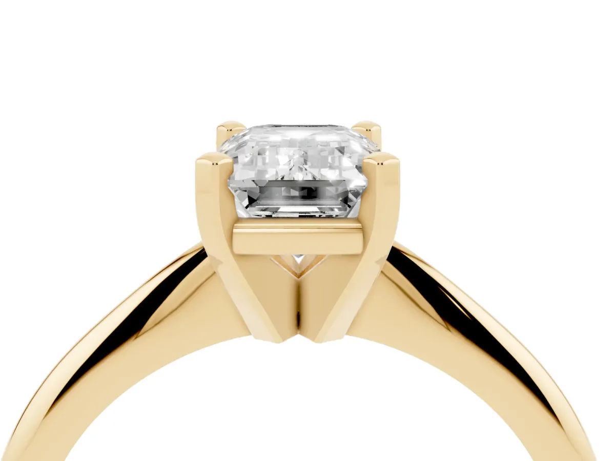 Emerald Cut Cut Solitaire Ring with Four-Prong Setting on a Classic Band Yellow gold
