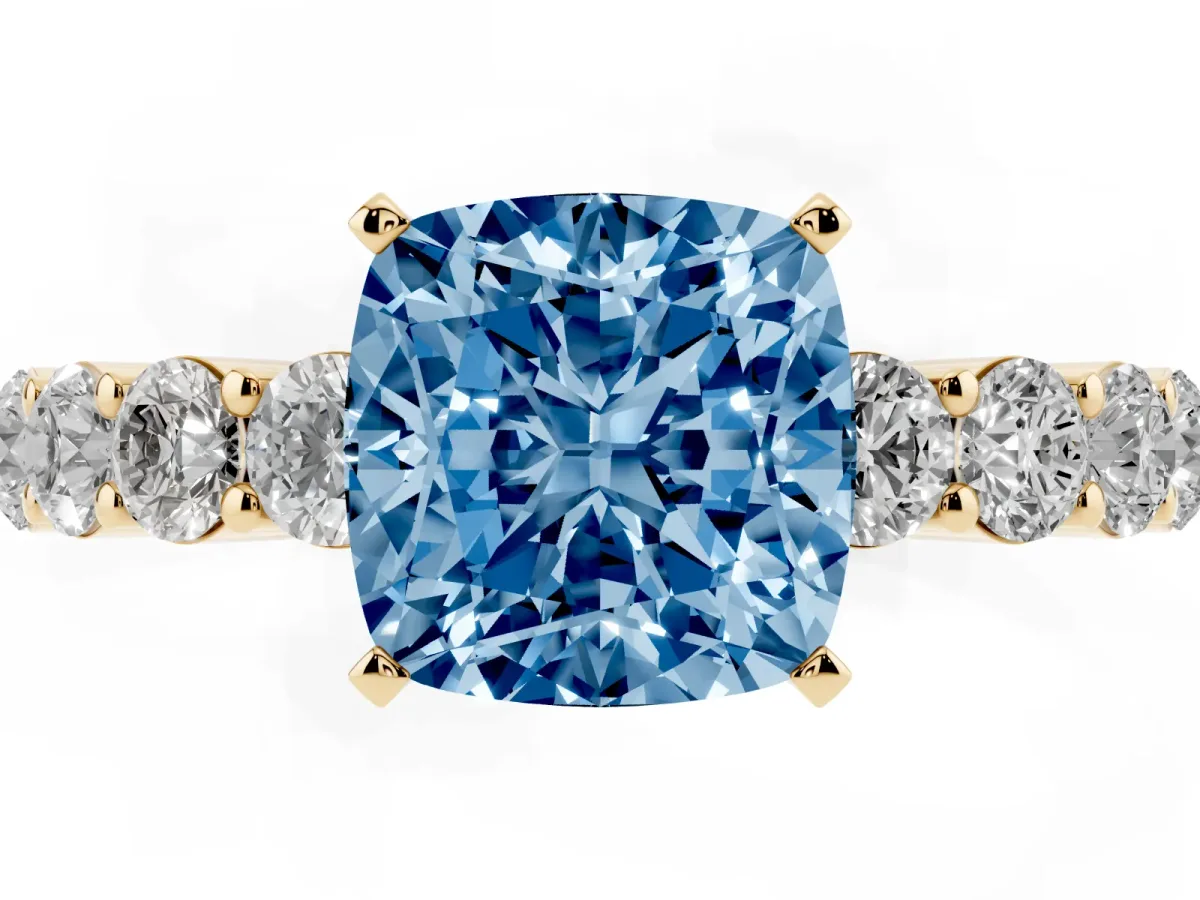 Fancy Blue Cushion Cut Diamond Solitaire Ring with Shared Prong Round Side Stones Yellow gold