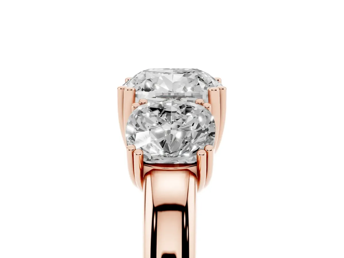 Three-Stone Cushion Cut Cut Diamond Ring with Channel Set Band and Four-Prong Setting Rose gold