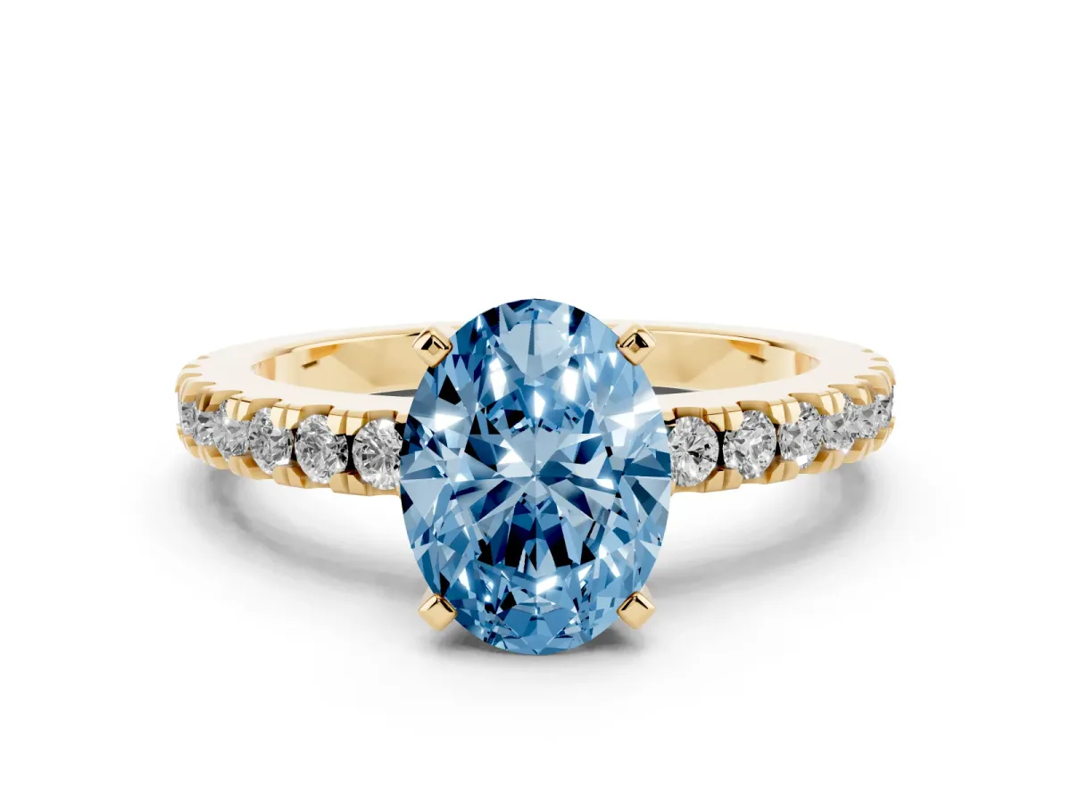 Fancy Blue Oval Cut Solitaire Diamond with Pavé Band and Four-Prong Setting Yellow gold