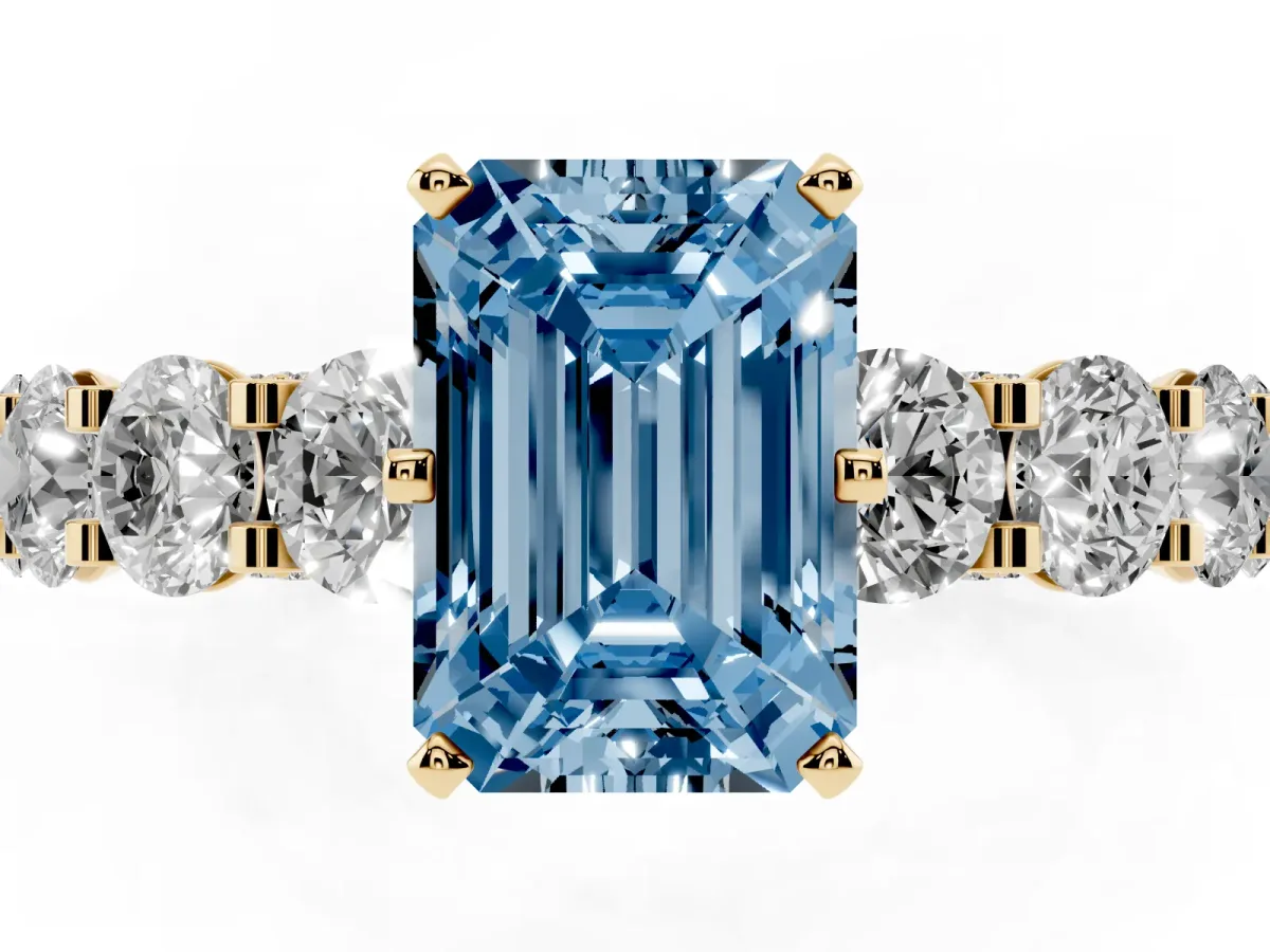 Fancy Blue Emerald Cut Diamond Side Stone Engagement Ring with Four-Prong Setting Yellow gold