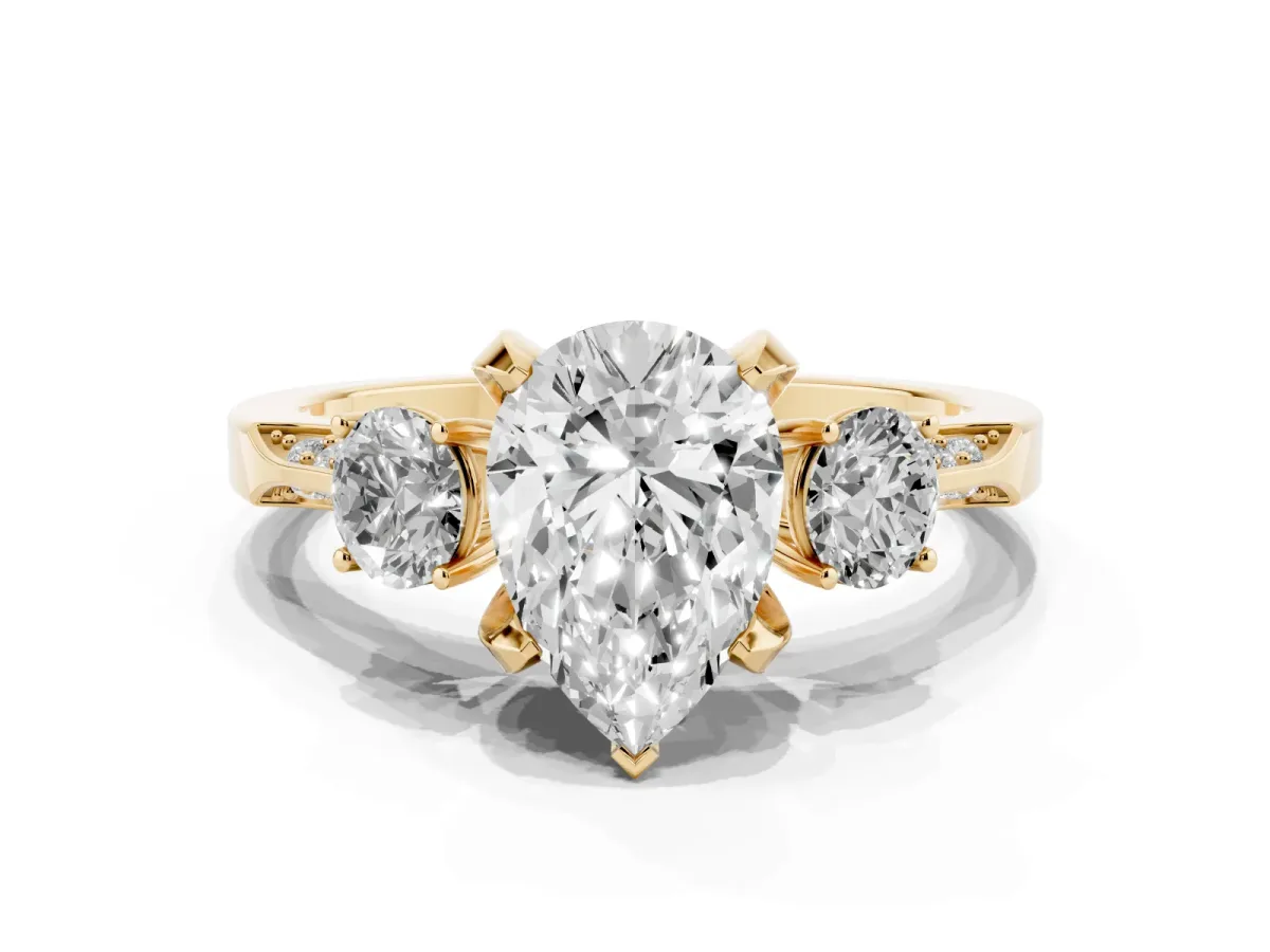 Pear Cut Brilliant Three-Stone Diamond Ring with Pavé Band and Four-Prong Setting Yellow gold