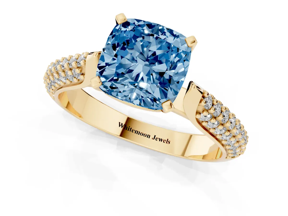 Fancy Blue Cushion Cut Diamond Solitaire Engagement Ring with Multi-Row Round Pavé Band and Prong Setting Yellow gold