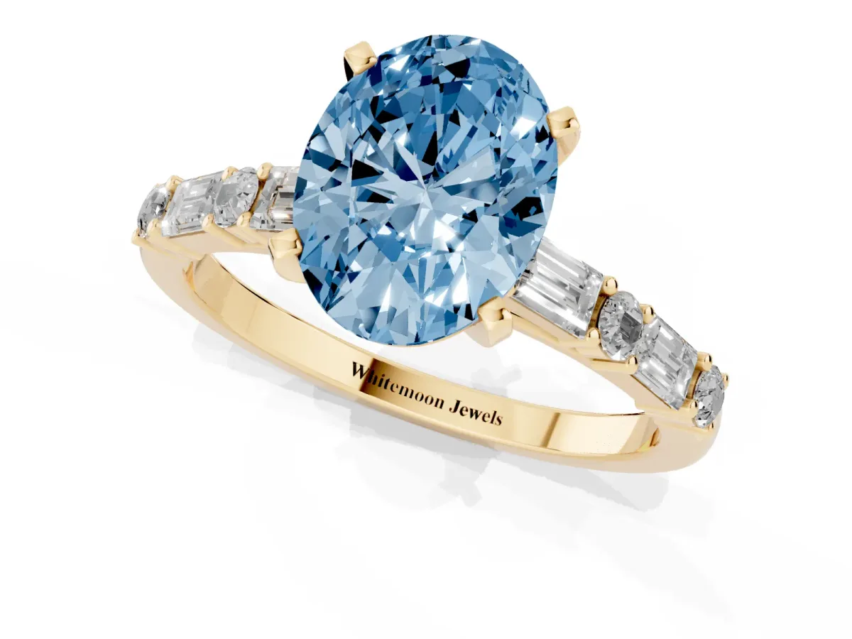 Fancy Blue Oval Cut Diamond Solitaire with Side Baguettes and Channel Set Band Yellow gold