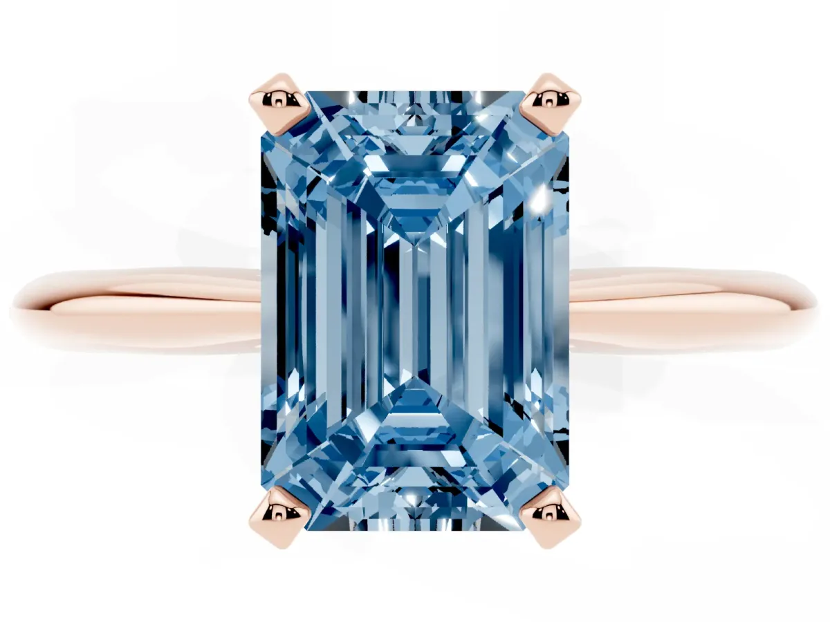 Fancy Blue Emerald Cut Cut Solitaire Ring with Four-Prong Setting on a Classic Band Rose gold