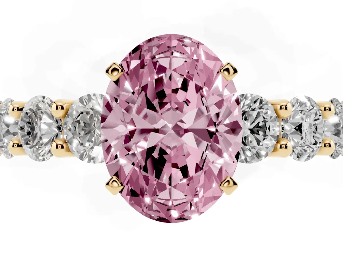 Fancy Pink Oval Cut Diamond Prong Setting with Side Stones on a Pave Band Yellow gold