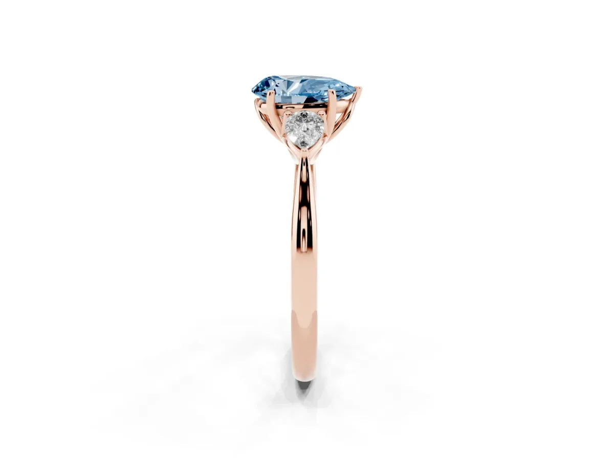 Fancy Blue Three-Stone Pear Cut Brilliant Diamond Solitaire Ring with Tapered Band and Four-Prong Setting Rose gold