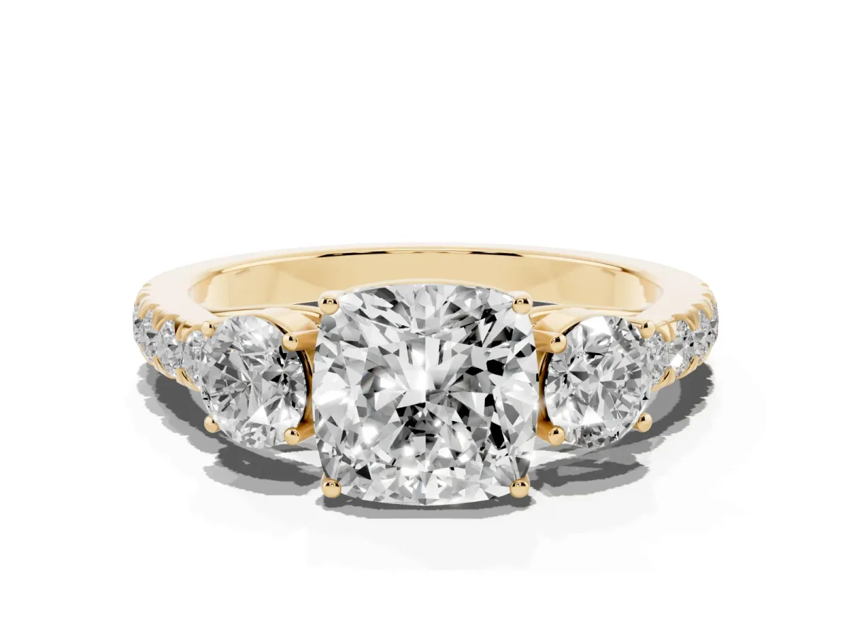 Cushion Cut Cut Diamond Three-Stone Ring with Round Side Stones and Pavé Band Yellow gold