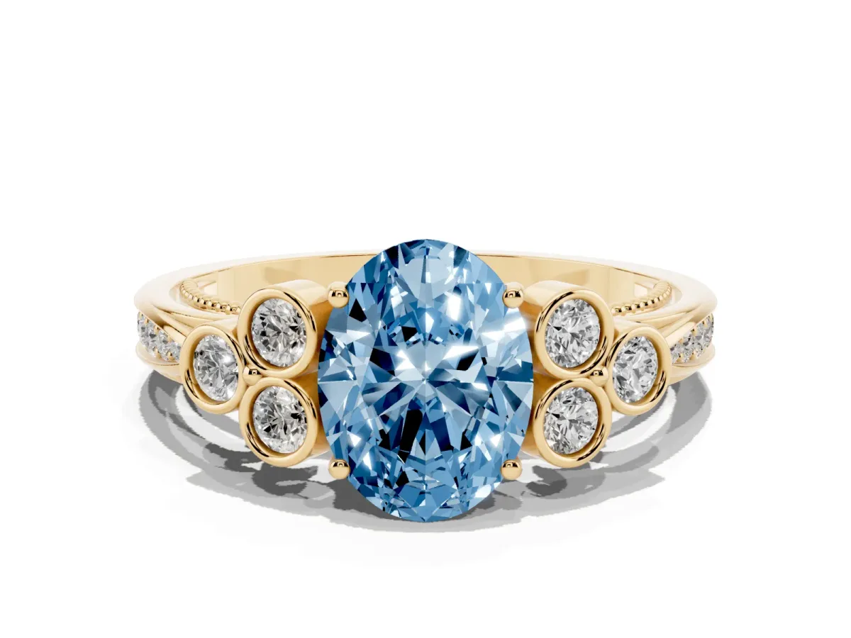 Fancy Blue Oval Cut Cut Diamond Engagement Ring with Bezel Set Round Side Stones and Prong Setting Yellow gold