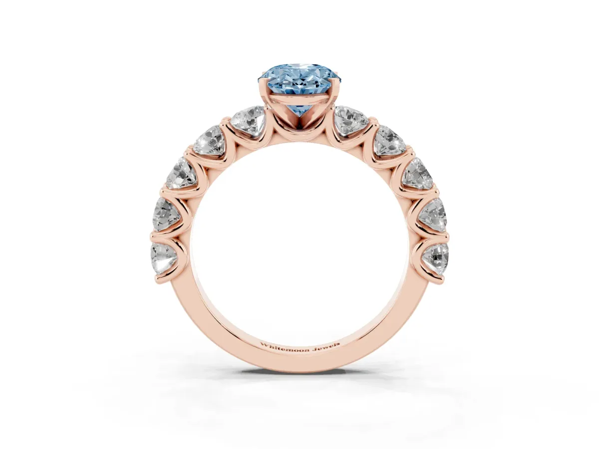 Fancy Blue Oval Cut Diamond Prong Setting with Side Stones on a Pave Band Rose gold