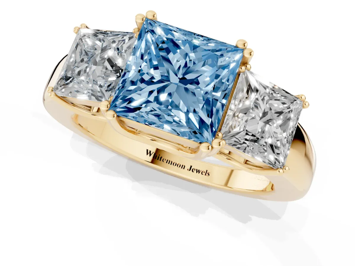 Fancy Blue Three-Stone Princess Cut Cut Diamond Ring with Channel Set Band and Four-Prong Setting Yellow gold