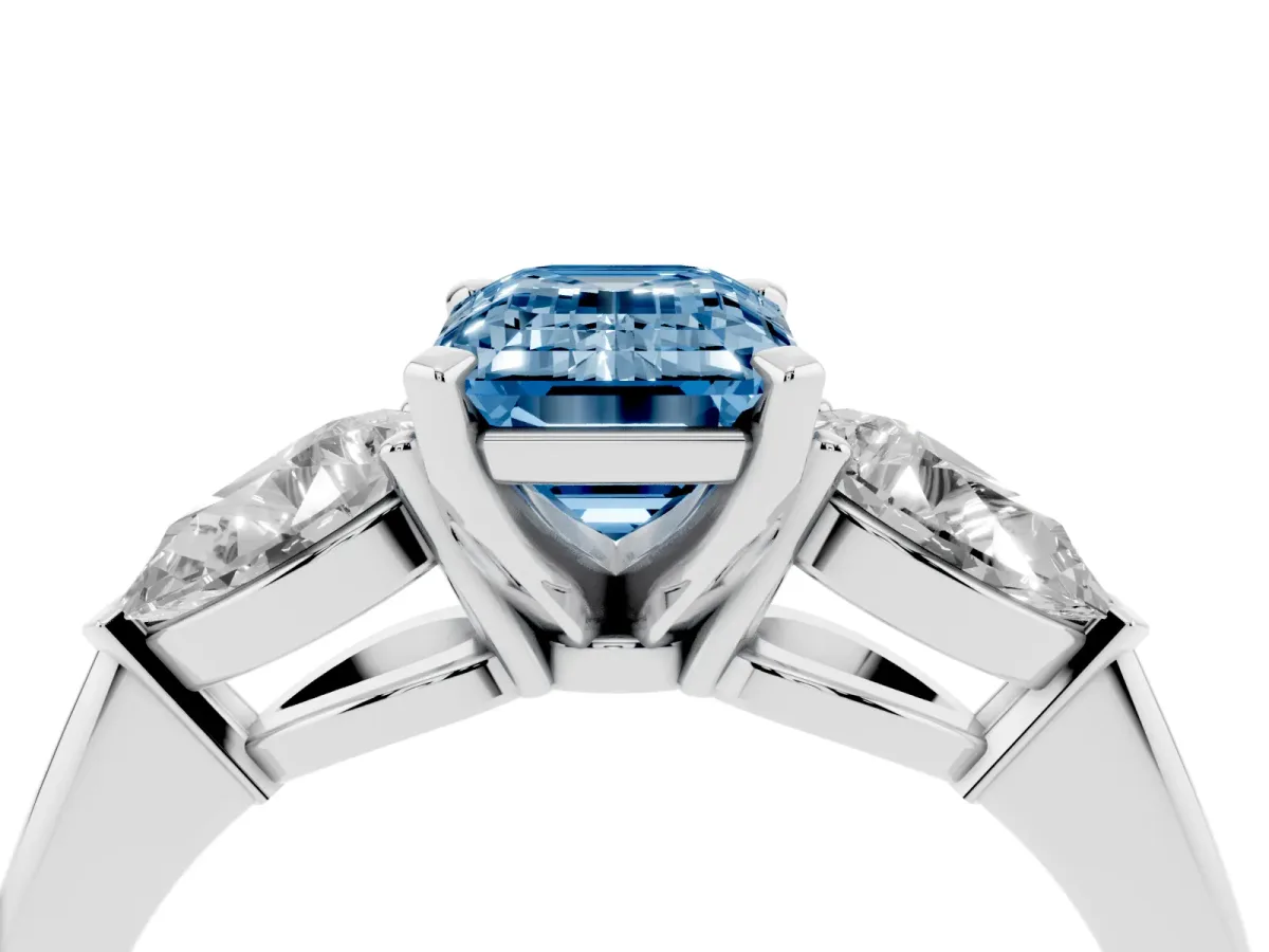 Fancy Blue Three-Stone Emerald Cut Diamond Ring with Pear Side Stones and Four-Prong Setting Platinum