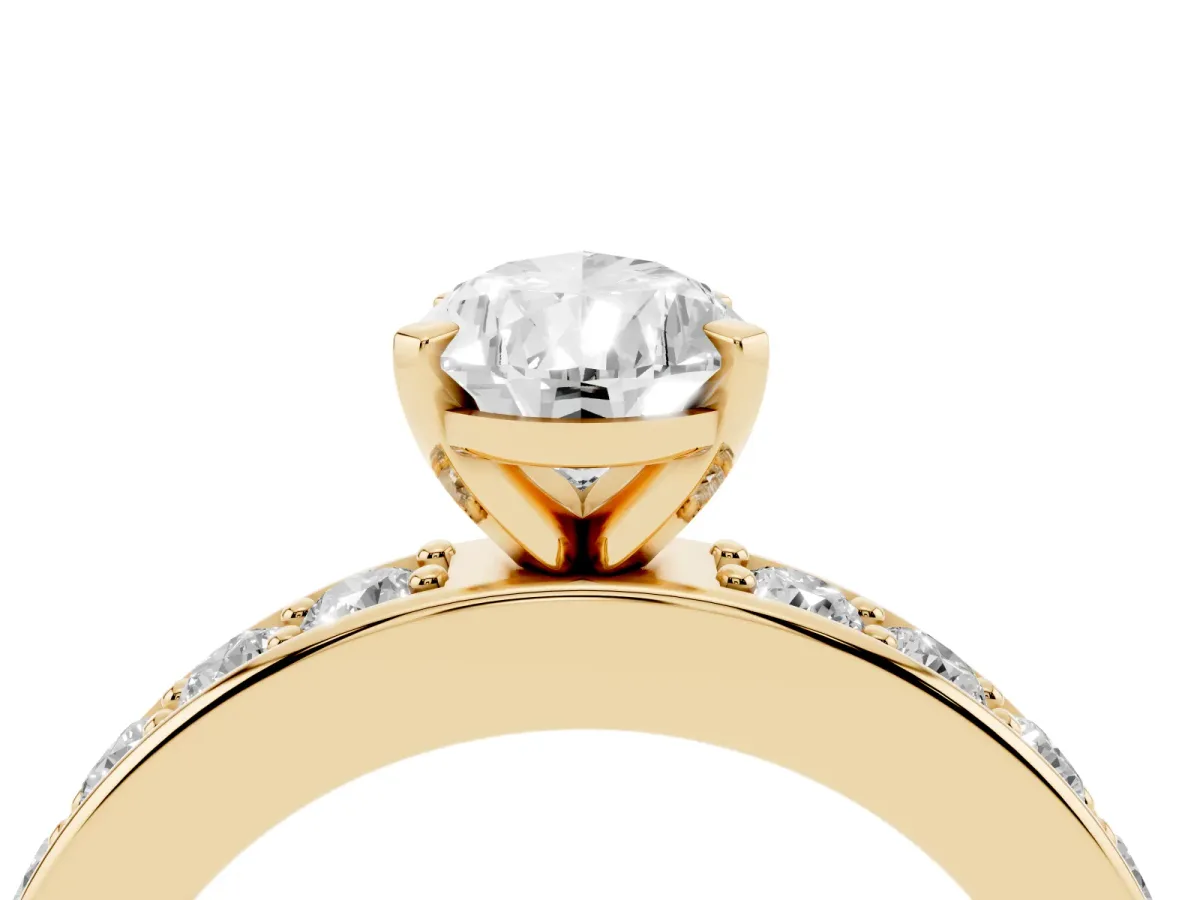 Pear Cut Diamond Engagement Ring with Channel Set Round Band and Prong Setting Yellow gold