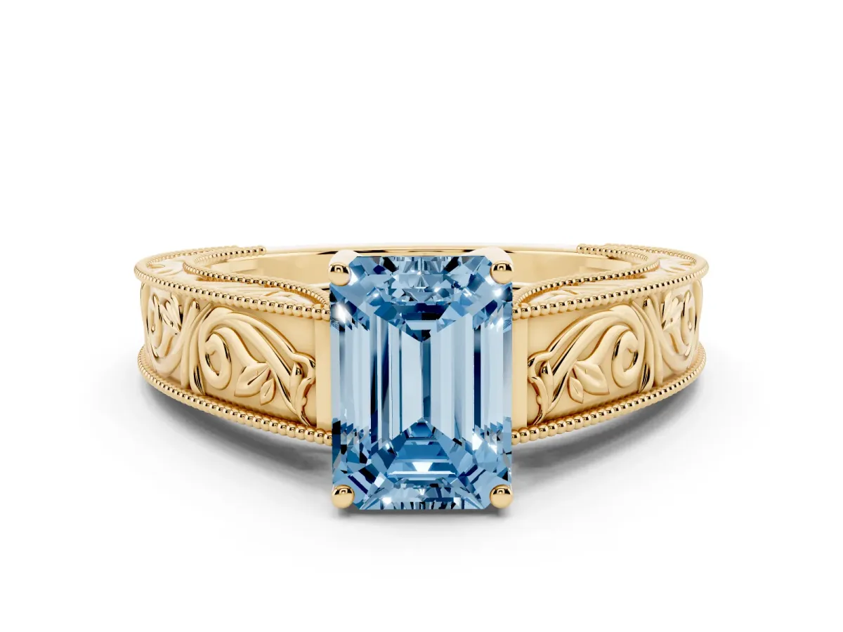 Fancy Blue Emerald Cut Diamond Solitaire Ring with Engraved Band and Four-Prong Setting Yellow gold
