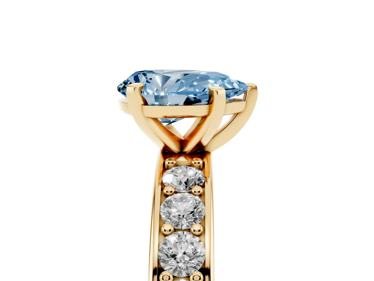 Fancy Blue Pear Cut Diamond Engagement Ring with Channel Set Round Band and Prong Setting Yellow gold