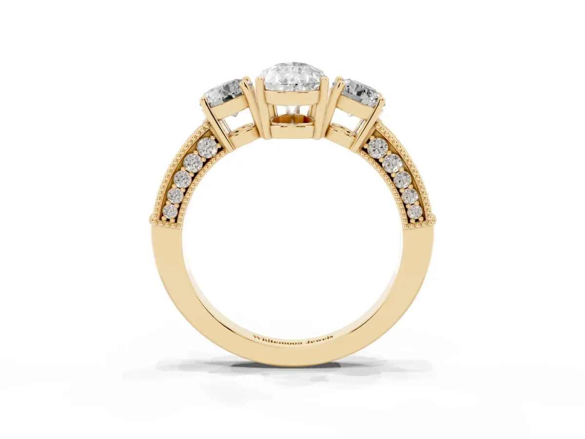 Pear Cut Three-Stone Diamond Ring with Pavé Band and Four-Prong Setting Yellow gold