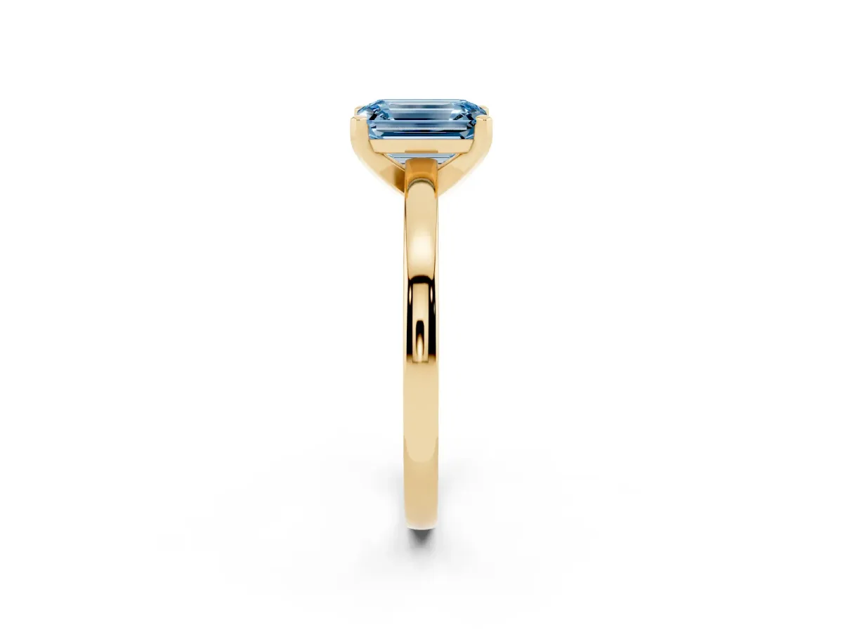 Fancy Blue Emerald Cut Solitaire Diamond Engagement Ring with Four-Prong Setting on a Classic Band Yellow gold