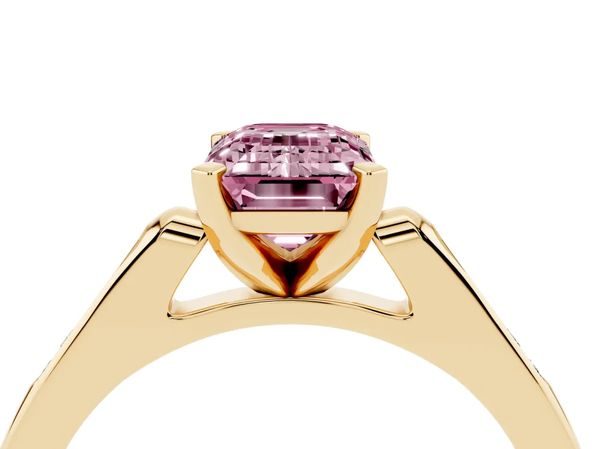 Fancy Pink Emerald Cut Diamond Solitaire Ring with Channel Set Round Band and Prong Setting Yellow gold