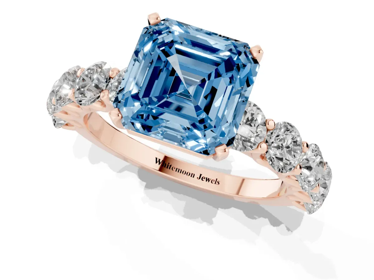 Fancy Blue Asscher Cut Diamond Prong Setting with Side Stones on a Pave Band Rose gold