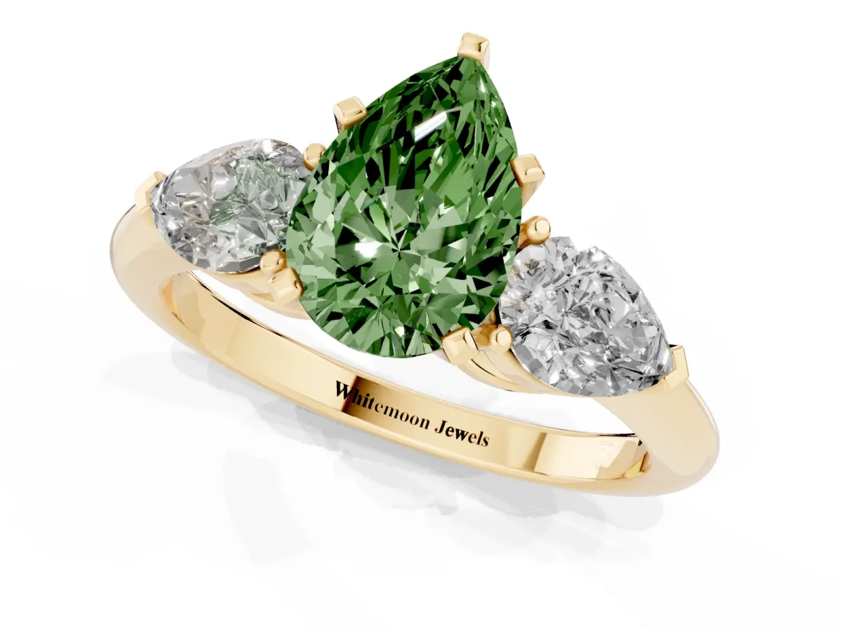 Fancy Green Three-Stone Pear Cut Diamond Ring with Pear Side Stones and Four-Prong Setting Yellow gold