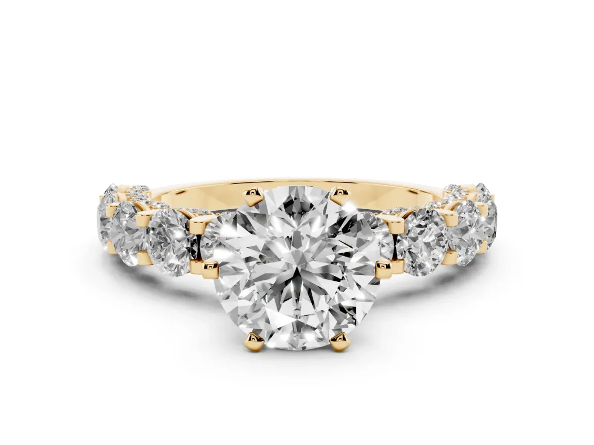Round Cut Diamond Side Stone Engagement Ring with Four-Prong Setting Yellow gold