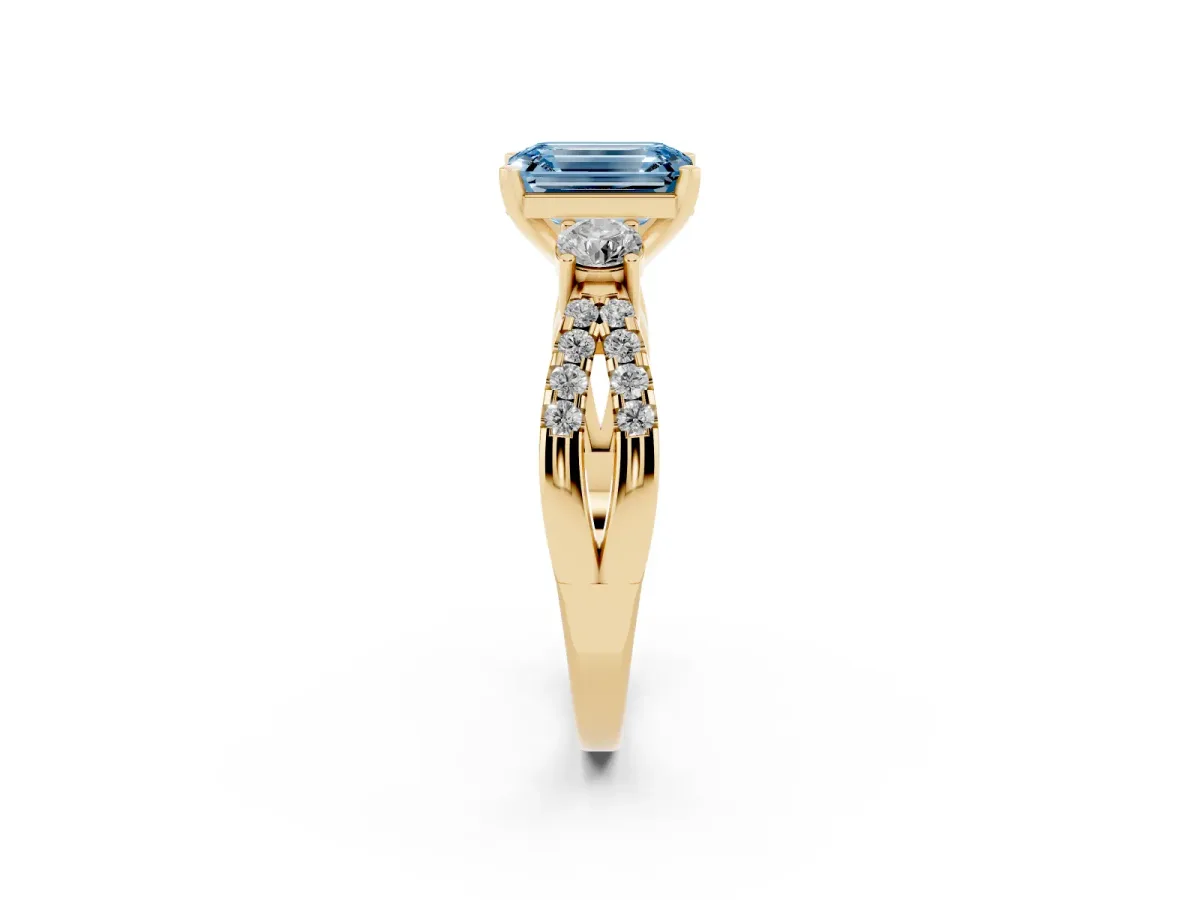 Fancy Blue Emerald Cut Diamond Three-Stone Ring with Pavé Split Shank and Four-Prong Setting Yellow gold