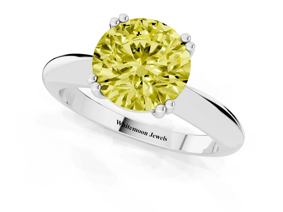 Fancy Yellow Round Cut Cut Solitaire Engagement Ring with Tapered Band and Four-Prong Setting Silver