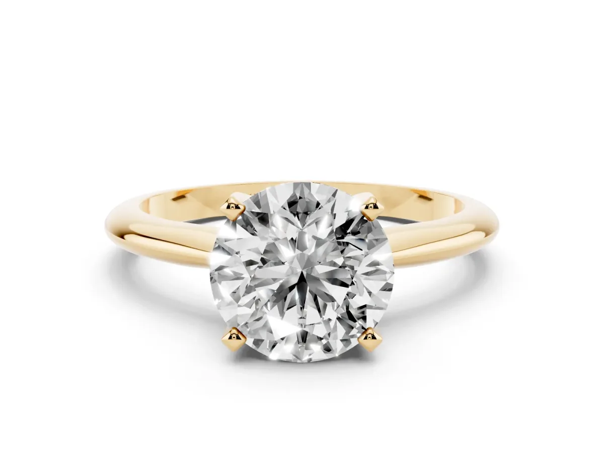 Round Cut Cut Solitaire Ring with Four-Prong Setting on a Classic Band Yellow gold