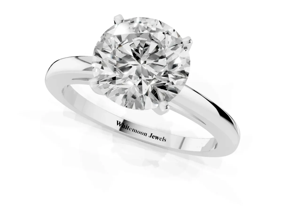 Round Cut Solitaire Diamond Engagement Ring with Four-Prong Setting on a Classic Band Silver