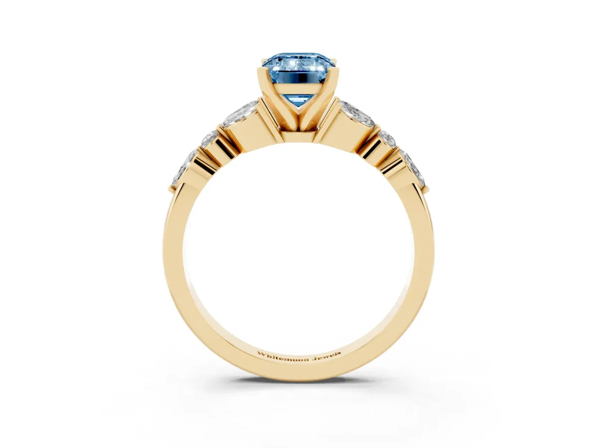 Fancy Blue Emerald Cut Diamond Solitaire Ring with Side Stones and Four-Prong Setting Yellow gold