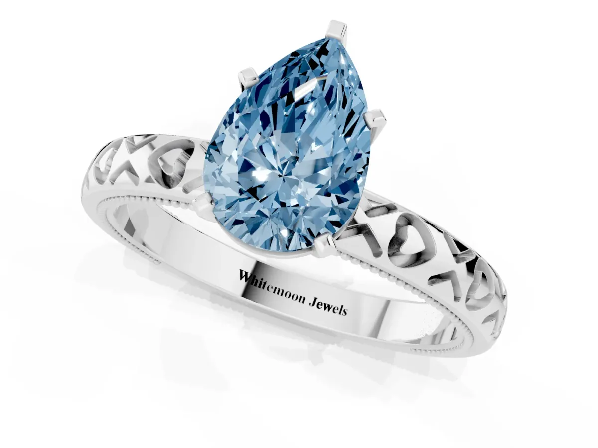 Fancy Blue Pear Cut Solitaire Diamond Engagement Ring with XO Engraved Band and Four-Prong Setting White gold