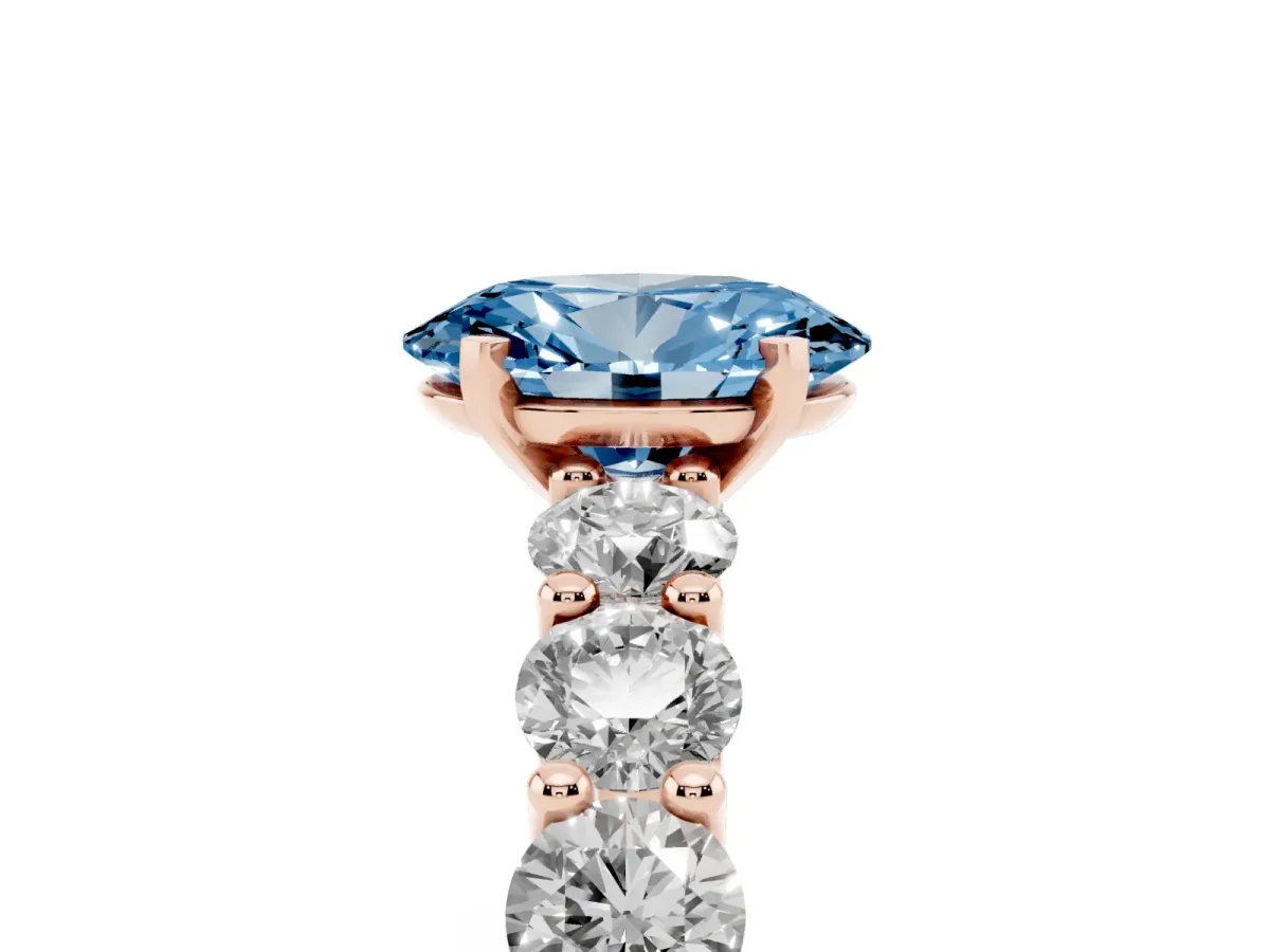 Fancy Blue Oval Cut Diamond Prong Setting with Side Stones on a Pave Band Rose gold